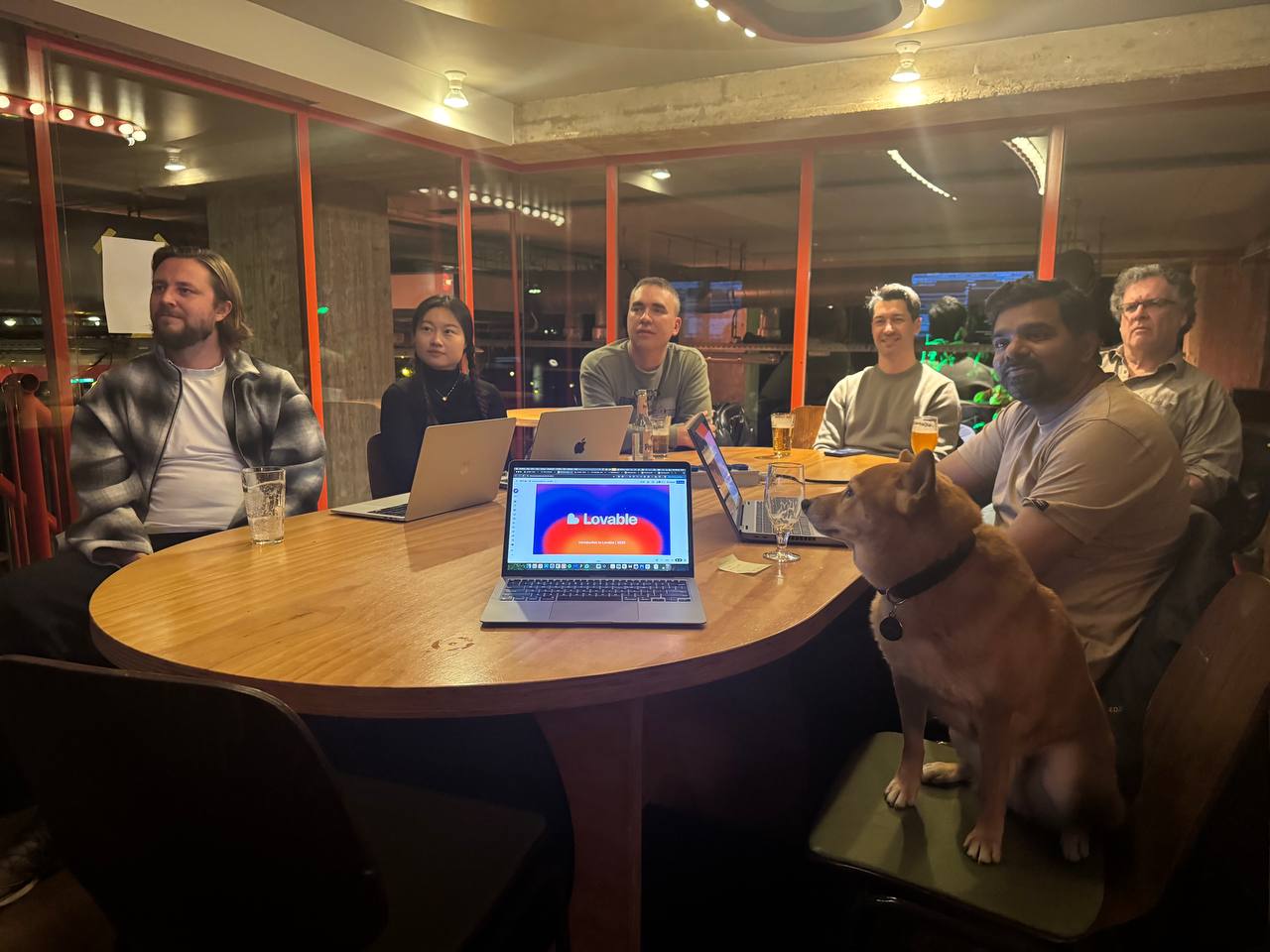 Builders working around a shared table at a Lovable community meetup.